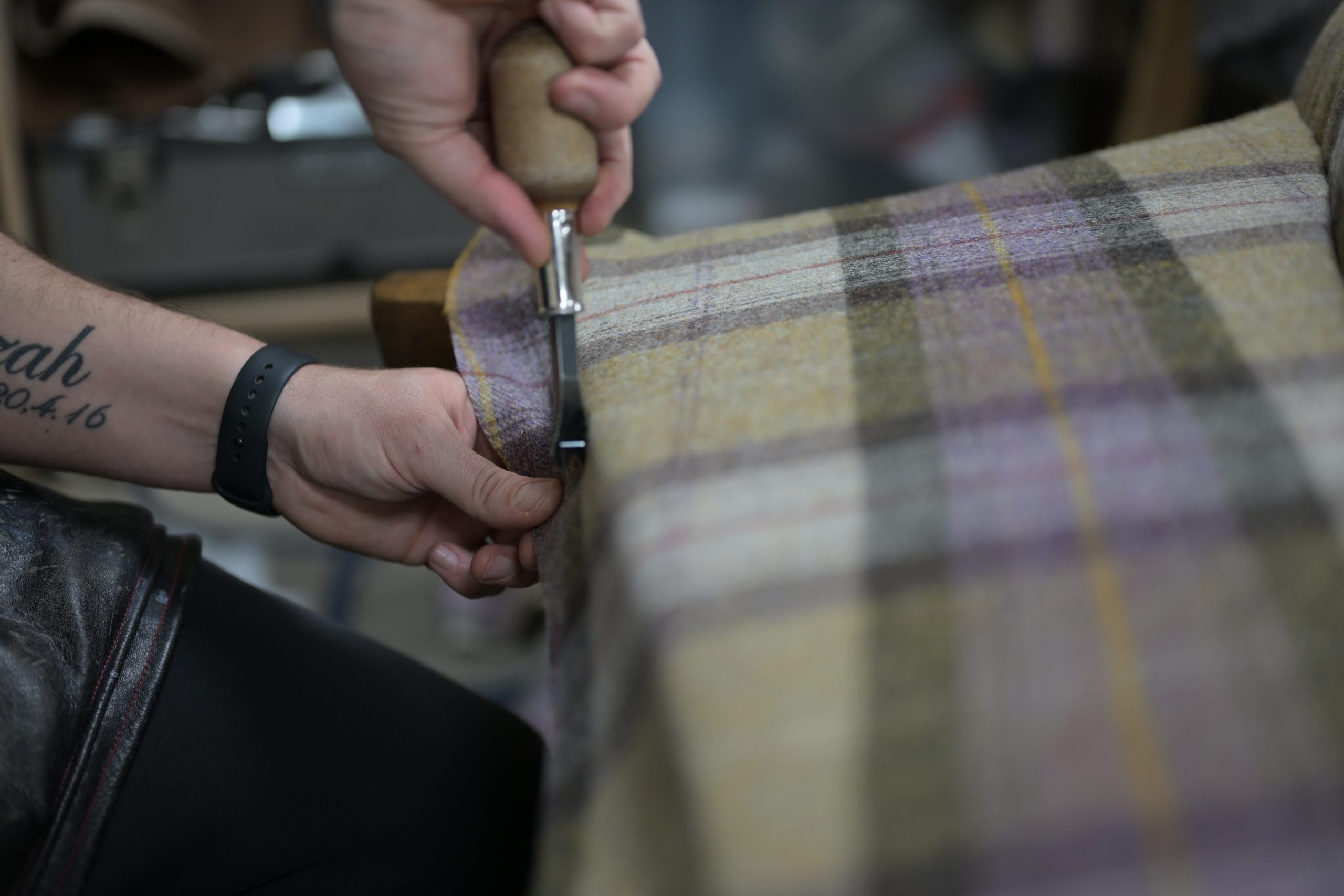 Cutting checked upholstery fabric by hand in the D&P workshop