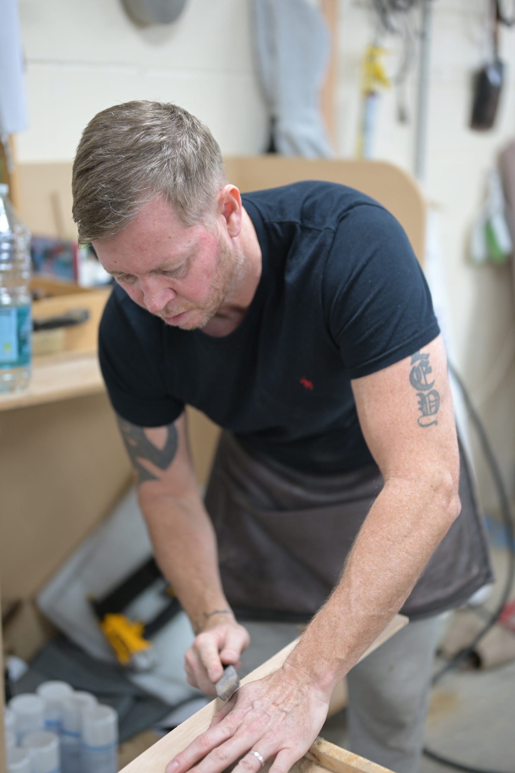 Scott shaping and upholstering furniture by hand in the D&P workshop